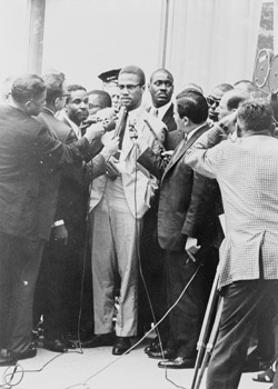Malcolm X with reporters